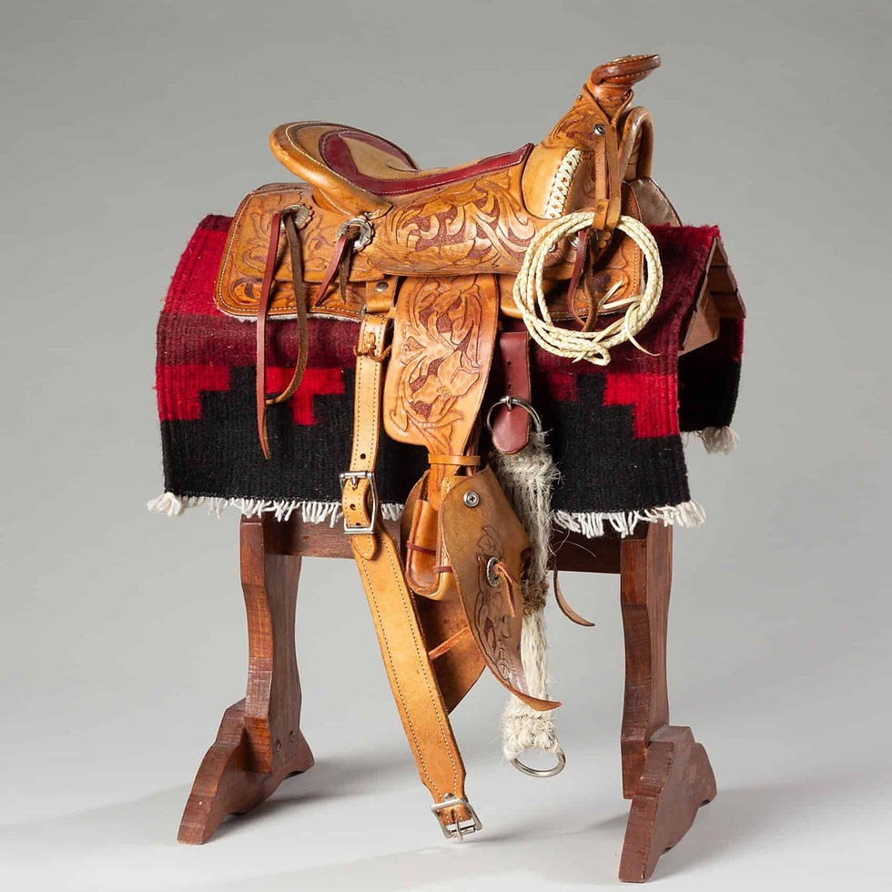 Miniature Western saddle with scale lariat, salesman sample collectible.