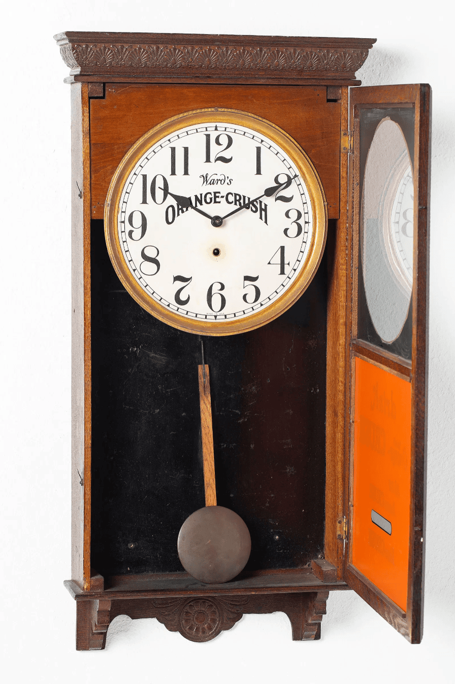Thumbnail: Open Clock dial and Orange Crush advertising on early 20th-century regulator clock