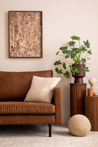 Modern composition of living room interior with mock up poster frame, brown sofa, beige co