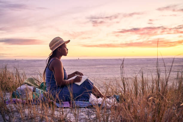 woman journaling on the beach