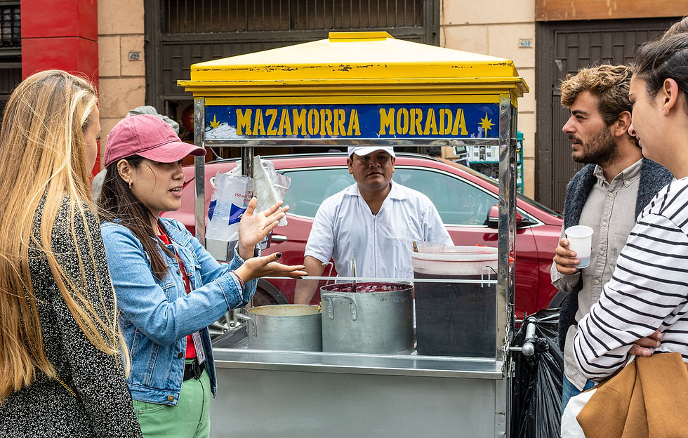 © Exquisito Peru: A group of tourists standing in front of a street stall selling mazamorra morada.