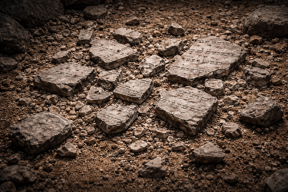Broken stone tablets with Hebrew text scattered on rocky ground, creating an ancient, archaeological setting. Exodus 32.