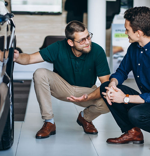 Auto industry professional reviewing insurance total loss valuation with client