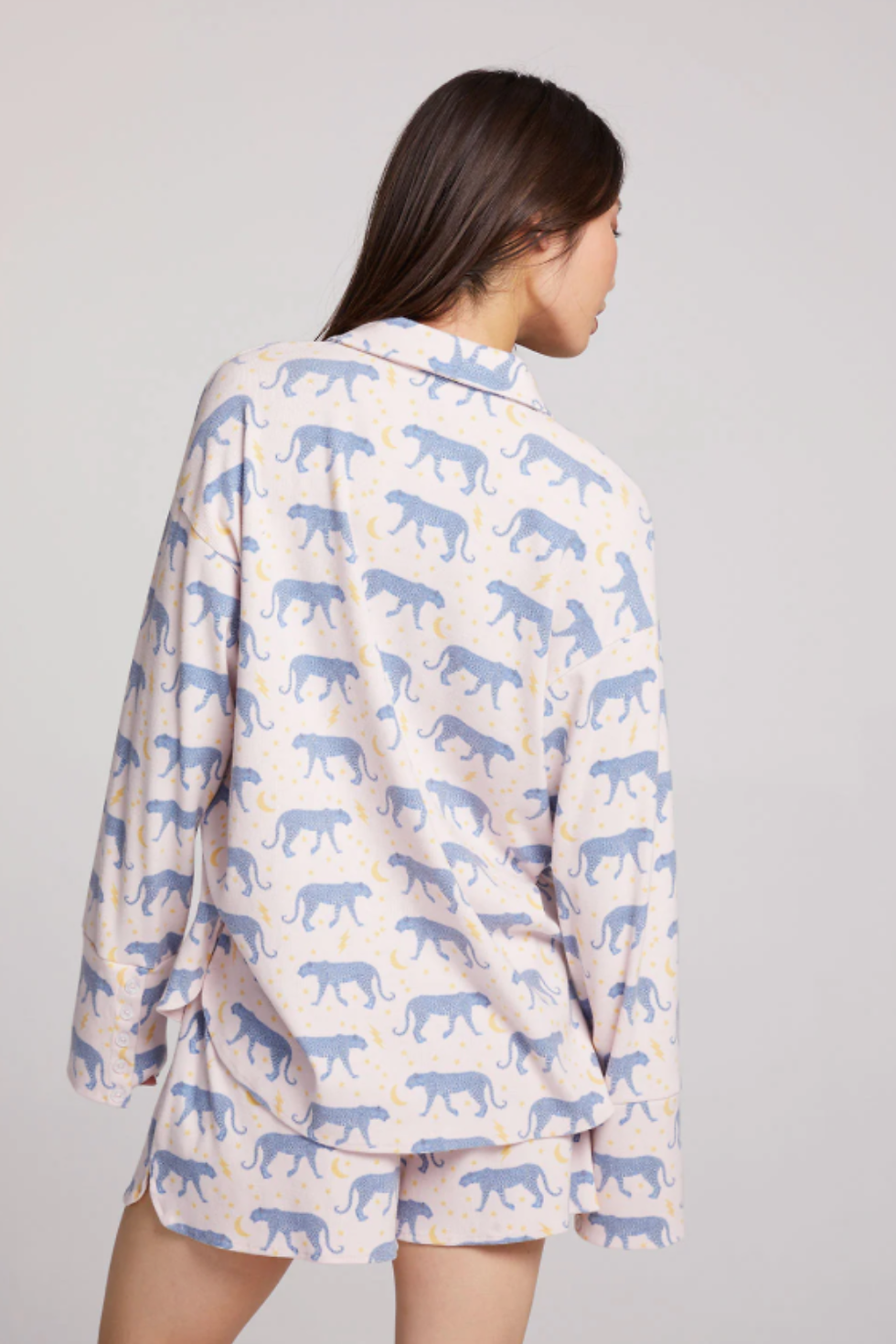 Thumbnail: Woman wearing blue leopard print long sleeve pajama top with button-down front