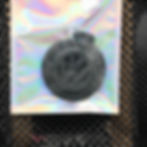 Thumbnail: Black VW logo keychain in packaging on a reflective surface.