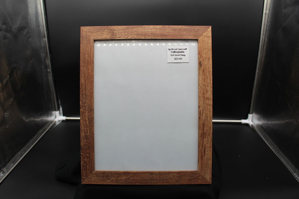 Wooden frame with white paper and a small label; SpellBound LaserCraft LLC.