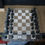 Thumbnail: Chessboard with black chess pieces in place ready for chess game. SpellBound LaserCraft LLC