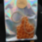 Apple Cinnamon Freshie with Apple Cinnamon text in shiny bag and background