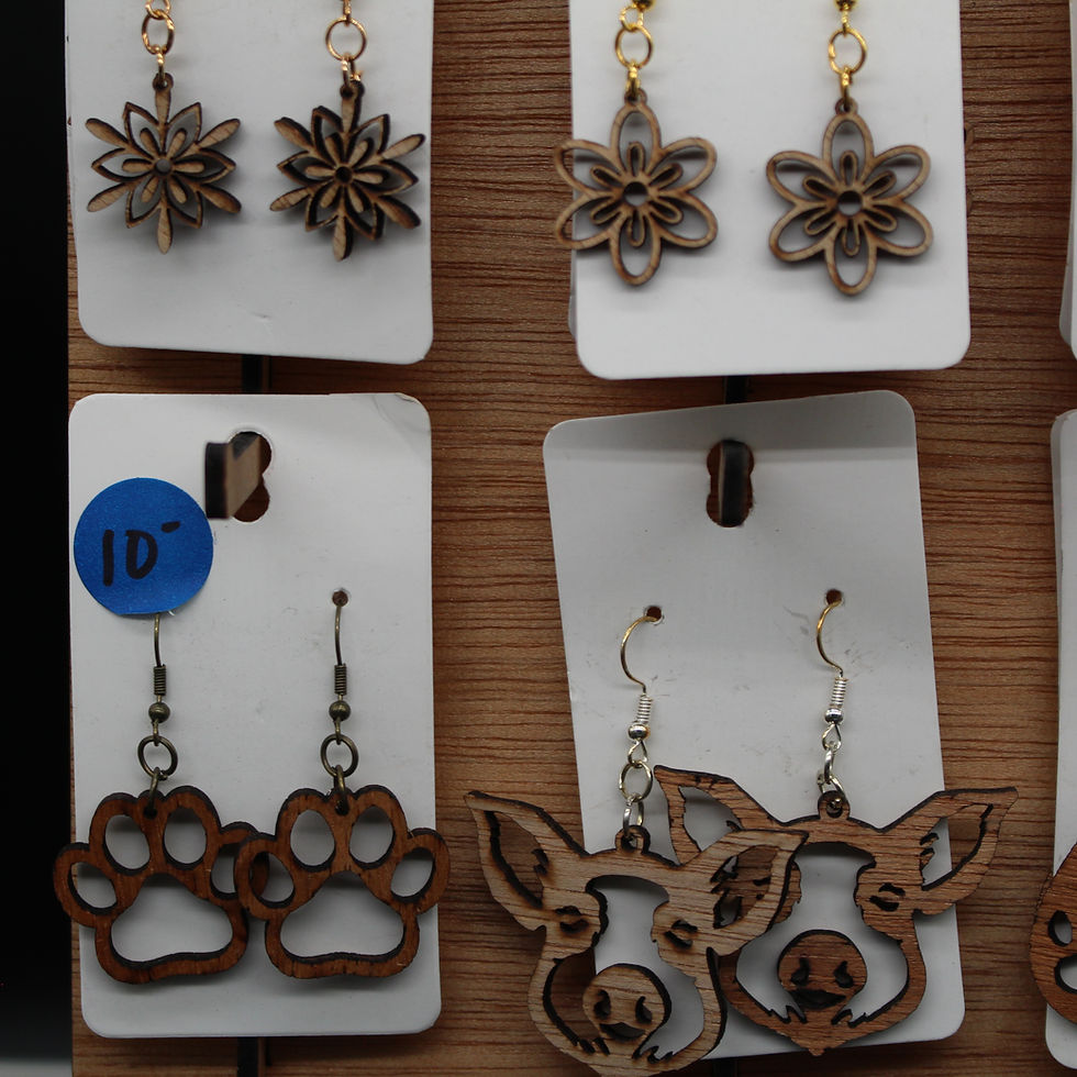 Thumbnail: Various wooden earrings hanging on display, including paw prints and flowers.