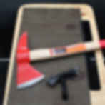 Thumbnail: Red axe, black grip, and a cutting board. Wood Wall Hanging. SpellBound LaserCraft LLC.