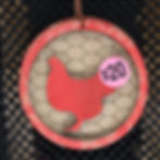 Red chicken keychain with $20 price tag, wooden detail, and wire background.