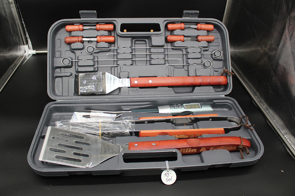 Open gray BBQ kit with tools and red handles ready for grilling season.