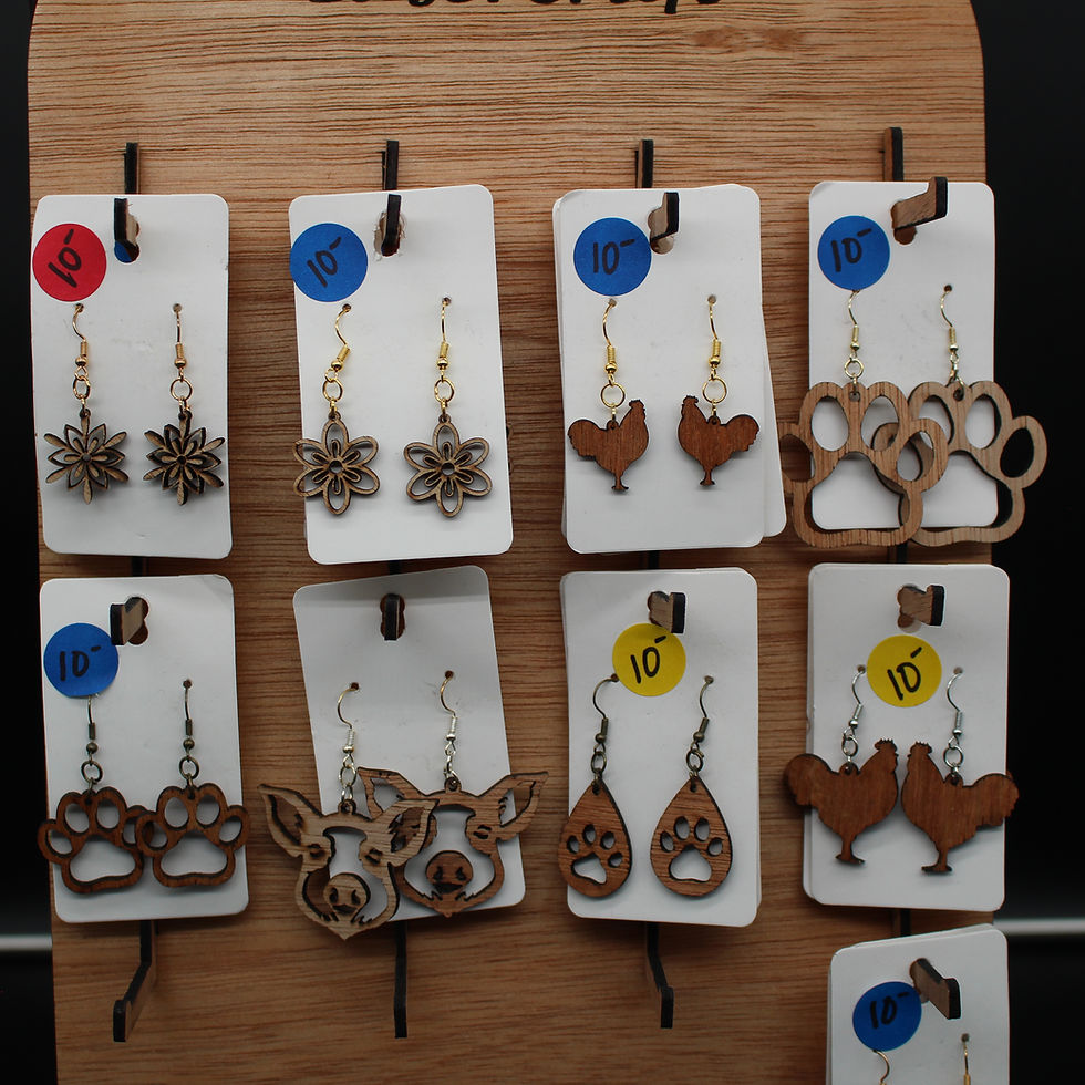 Thumbnail: Wooden earrings on display, featuring various shapes and designs, SpellBound LaserCraft LLC.