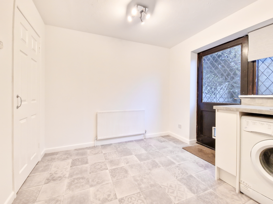 Modern kitchen with sleek countertops, stainless steel appliances, and custom cabinetry, showcasing a stunning refurbishment.