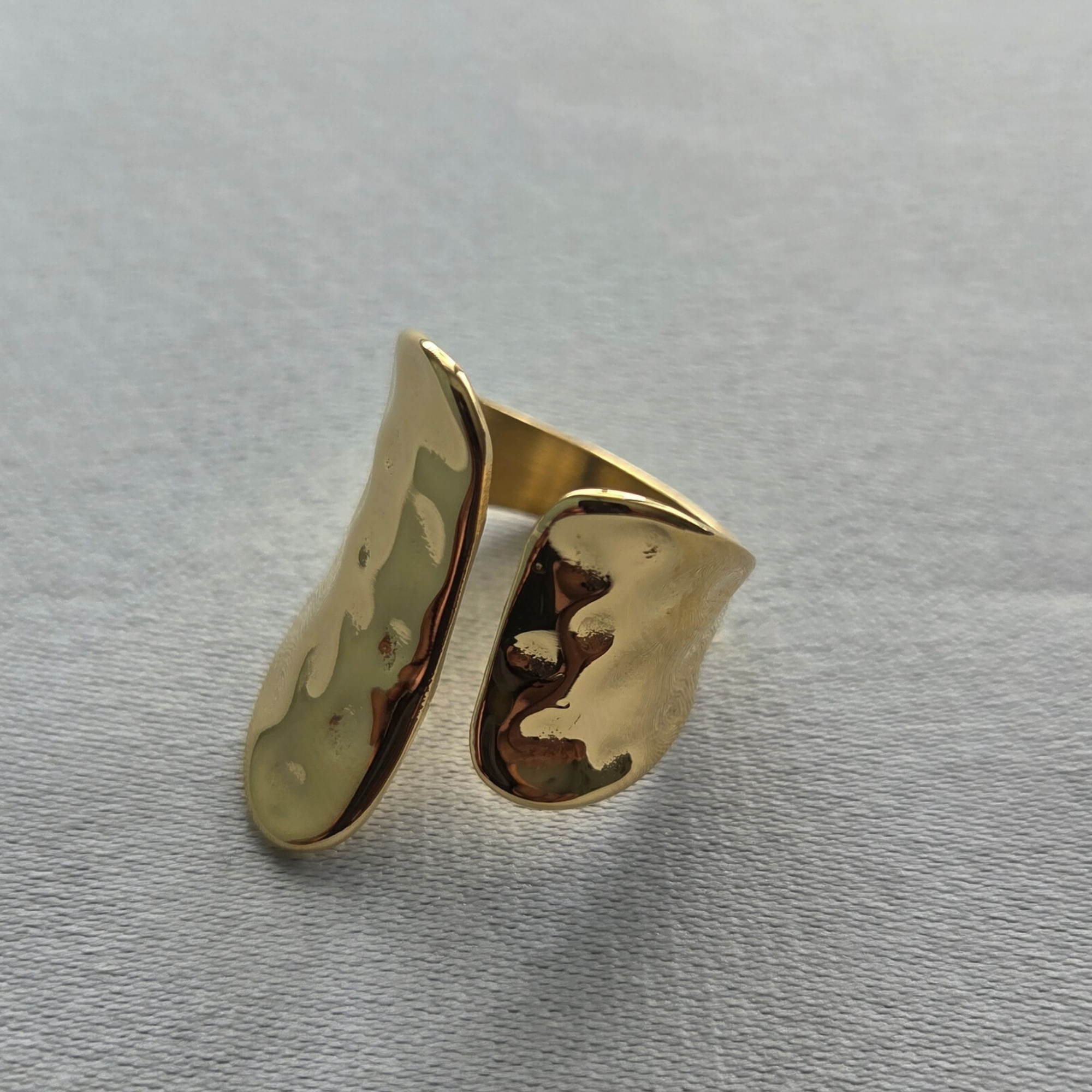 Ring No.2 Fold, a gold 316 stainless steel open ring with opposing sculptural folded planes.