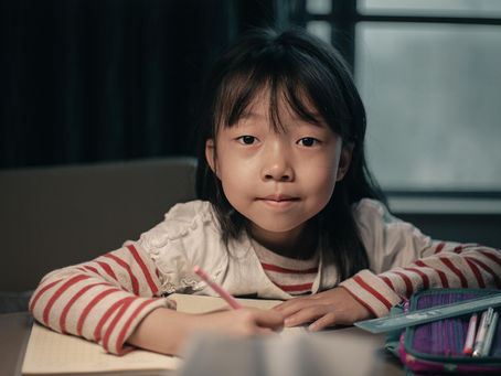 Young girl struggling to complete schoolwork