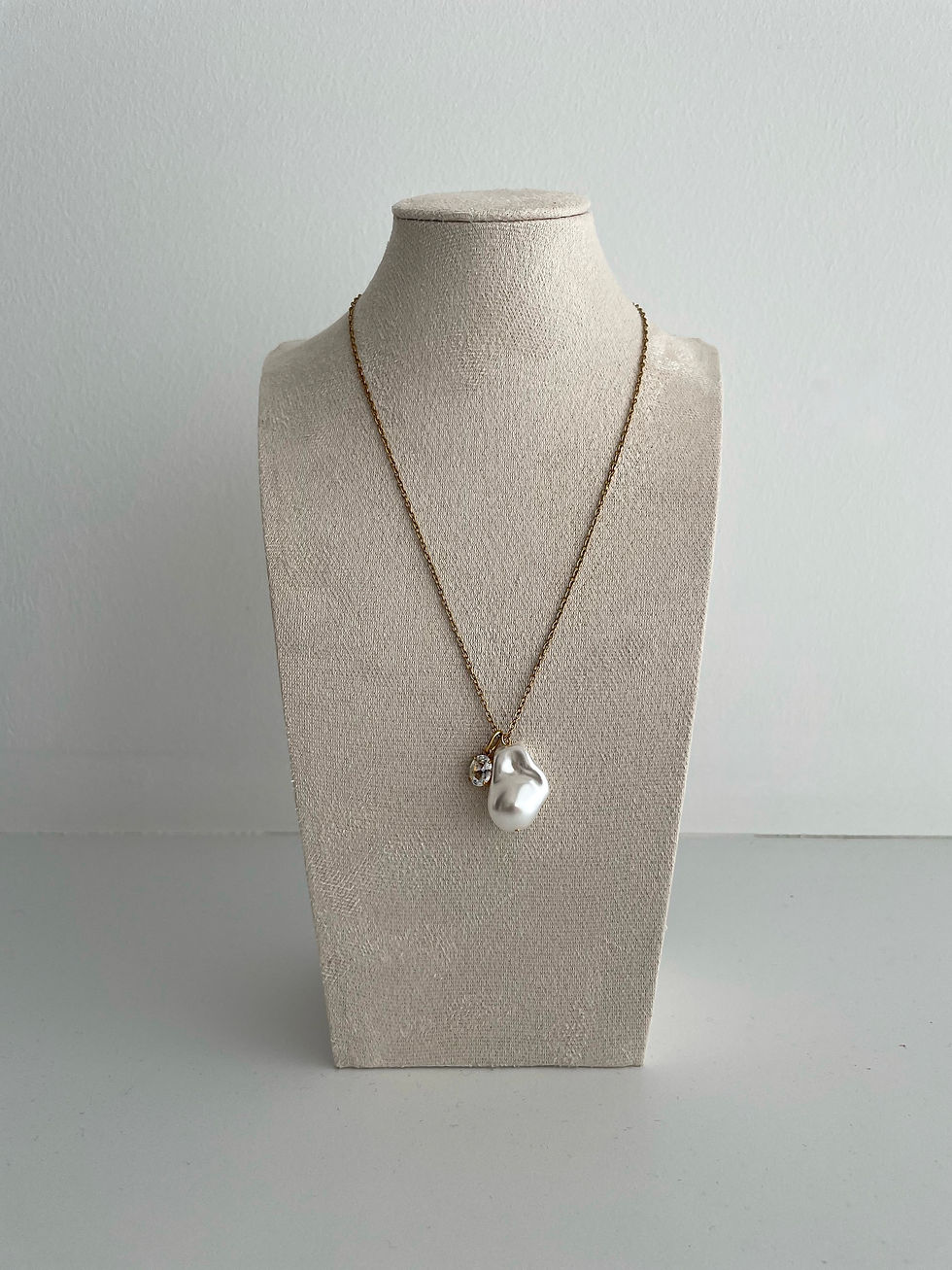 Single baroque freshwater pearl pendant necklace with a small zirconia diamond