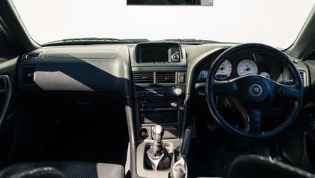 web-16x9_listing-images_Nissan-BNR34-VSpecII-White0022-interior-full-front.png