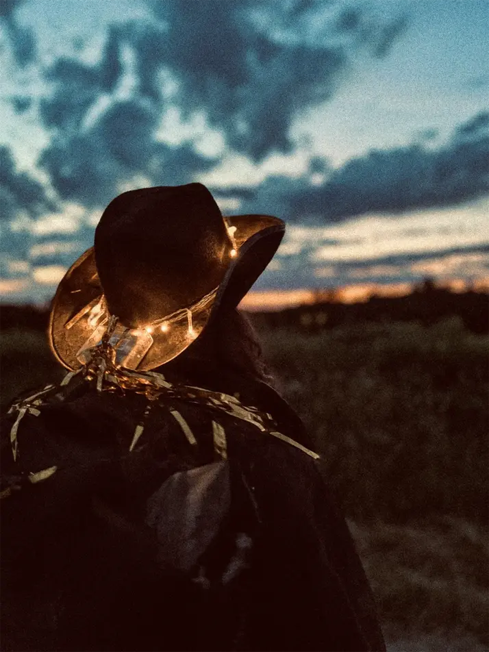 moody, sunset, woman, cowboy hat, lights, horizon, countryside, backpack
