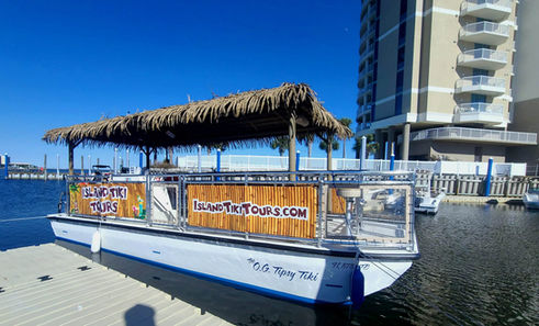 26 feet wide blue and white Tiki boat side view.