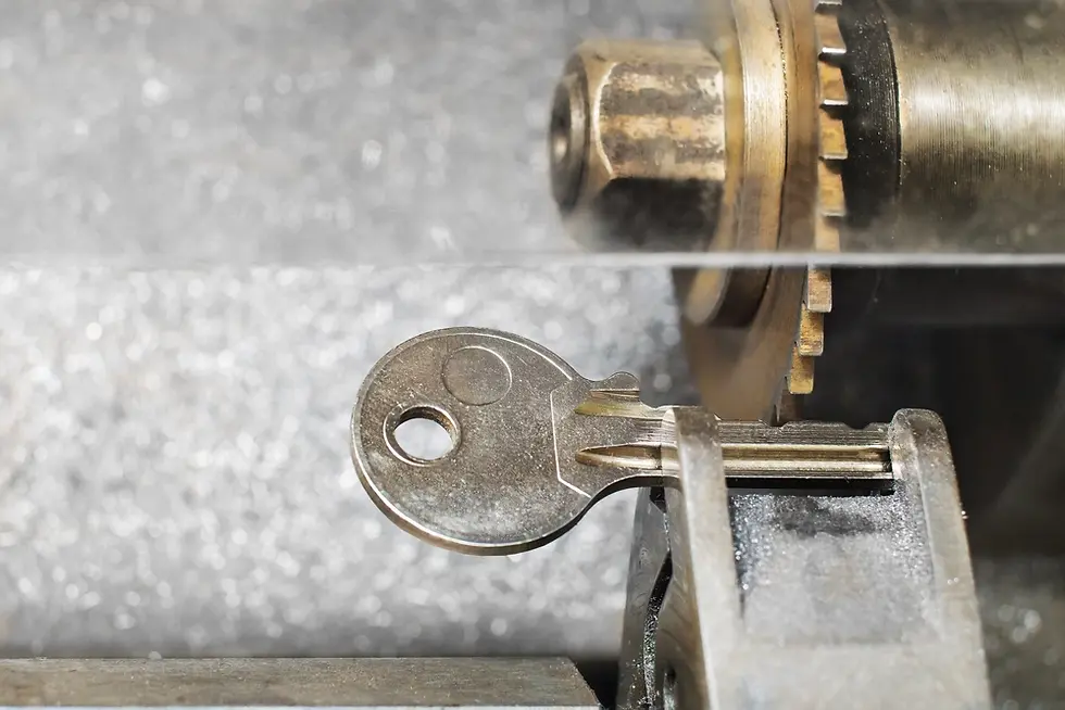 A key copy being cut in a manual key cutting machine.