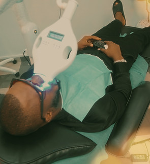 a man laying on a chair in a dentist's o