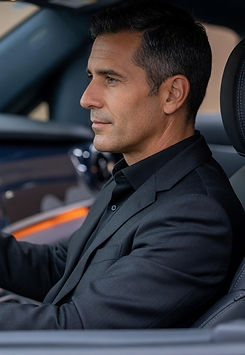 Professional driver holding the steering wheel inside the luxurious Mercedes-Benz V-Class, premium interior detail during a comfortable long-distance private transfer by MYEUTAXI