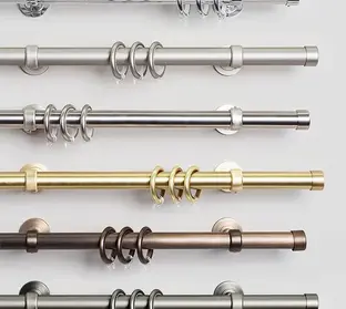 Decorative metal drapery pole with curtain rings.