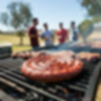 Traditional Boerewors Coiled sausage with other meats being cooked on a South African braai With men standing around