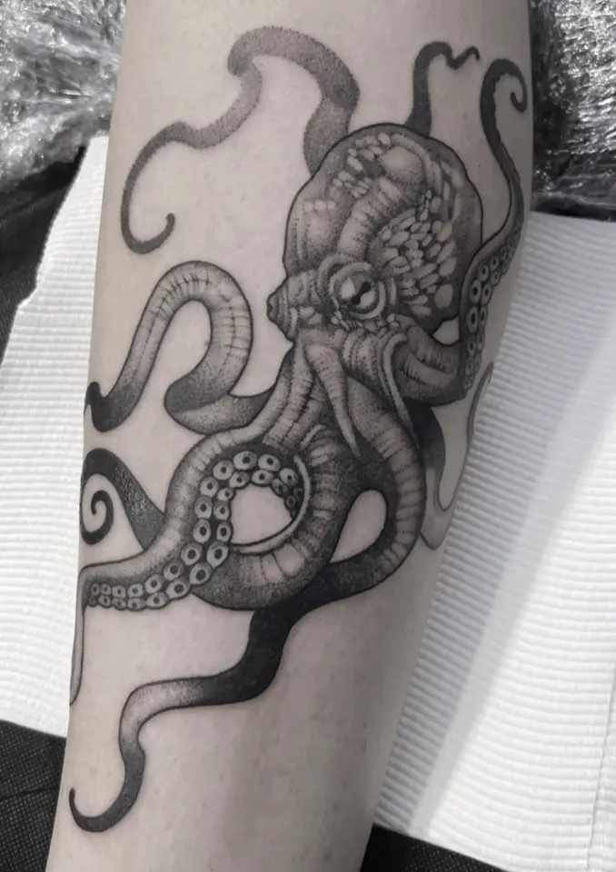 Epic octopus black and grey tattoo on man's arm