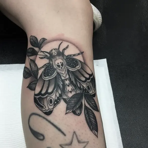 Large moth with bohemian patterns black tattoo
