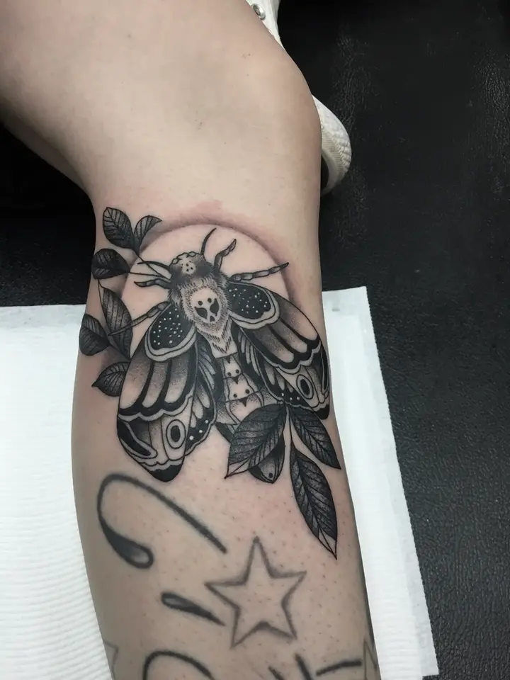 Large moth with bohemian patterns black tattoo