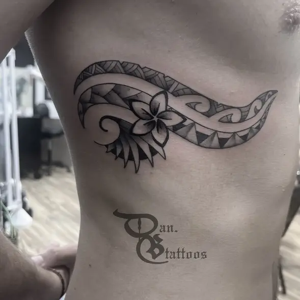 Pacific island inspired tattoo on man's ribs