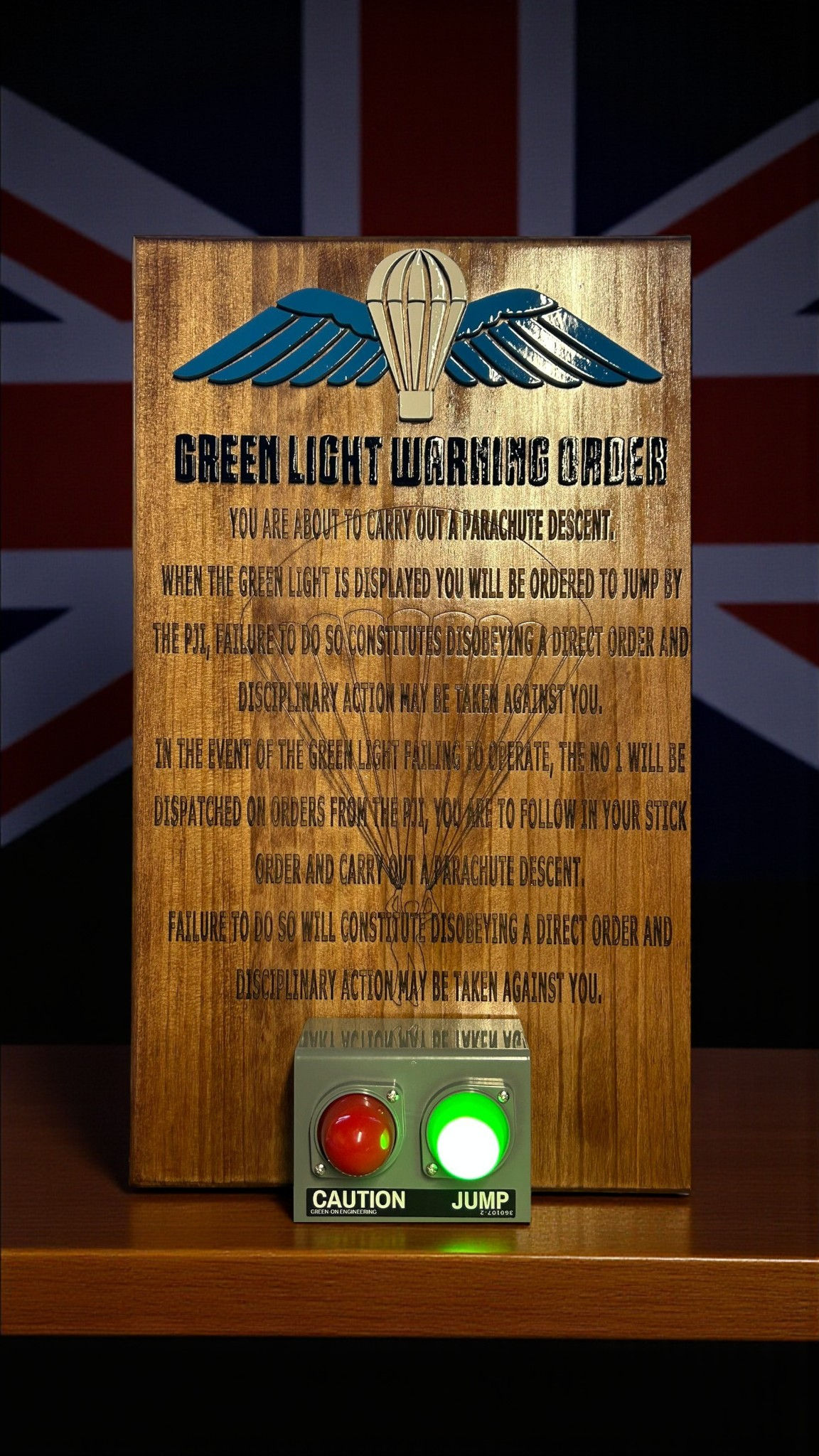 Wooden plaque with text and a green light: Green Light Warning Office. Frontline Laser Desi.
