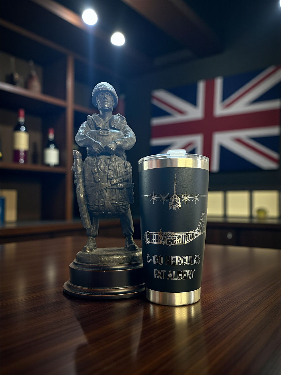 Thumbnail: Statue and a beverage container with text, Union Jack flag in background, wooden table.