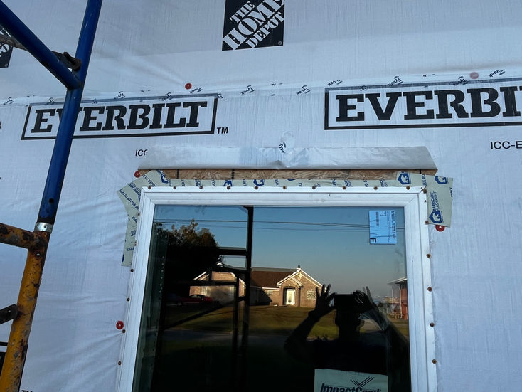 Exterior wall weather resistant barrier and newly installed window and window flashing