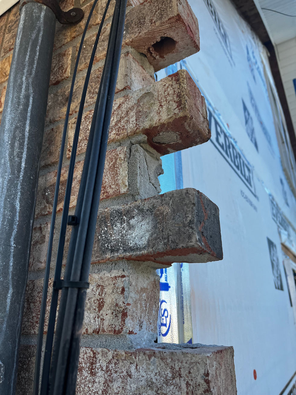 Exterior brick wall prep before repair in Pensacola, Florida