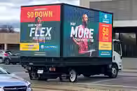 Digital mobile billboard truck promoting Pure Fitness gyms operating along high traffic roads in Tysons Virginia Springfield Virginia and Columbia Maryland during a regional advertising campaign