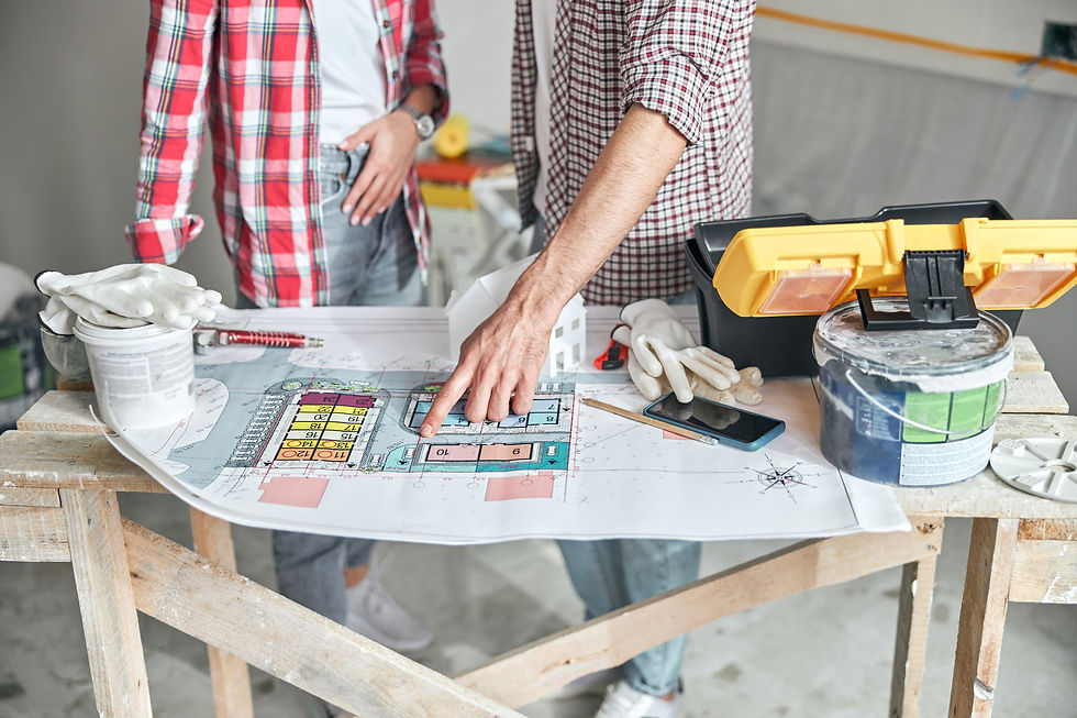 renovation team looking at floor plan