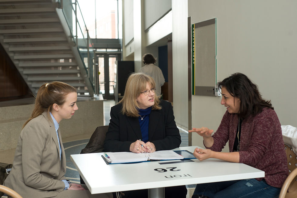 School for Conflict Analysis and Resolution professor Pamela Struss works with Jenna Letsch (L) and Ruba Hindi at the Fairfax Campus.