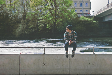 Guy sitting on bridge