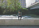Guy sitting on bridge
