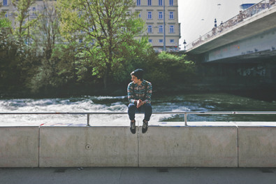 Guy sitting on bridge