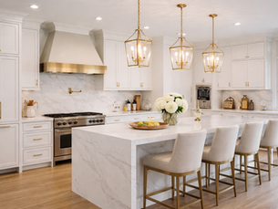 High-end kitchen remodel in Portland Oregon with white custom cabinets, quartz island, gold fixtures, and pendant lighting