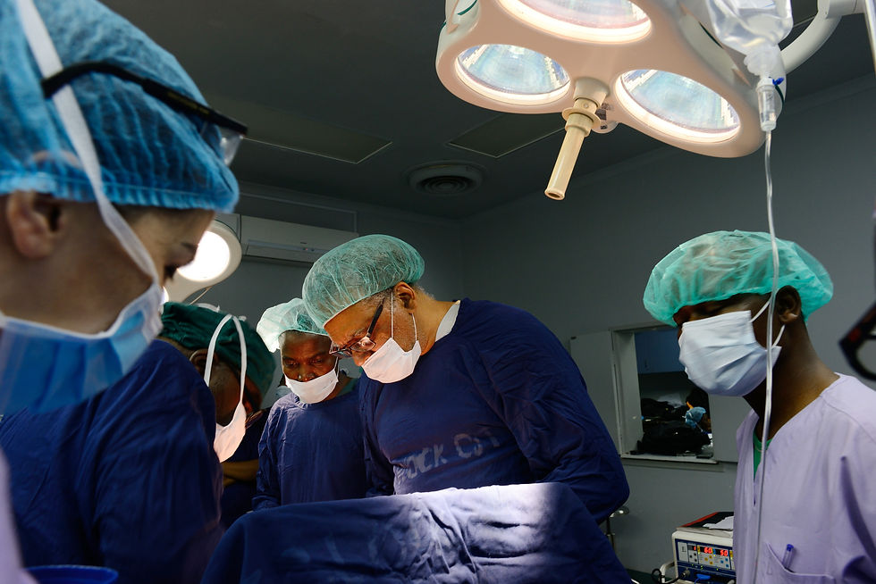 Prof Parham teaching cancer surgery to Dr. Chisele.jpg