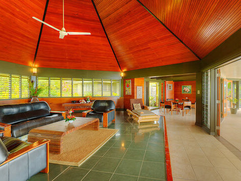 Spacious resort lounge with high red ceiling