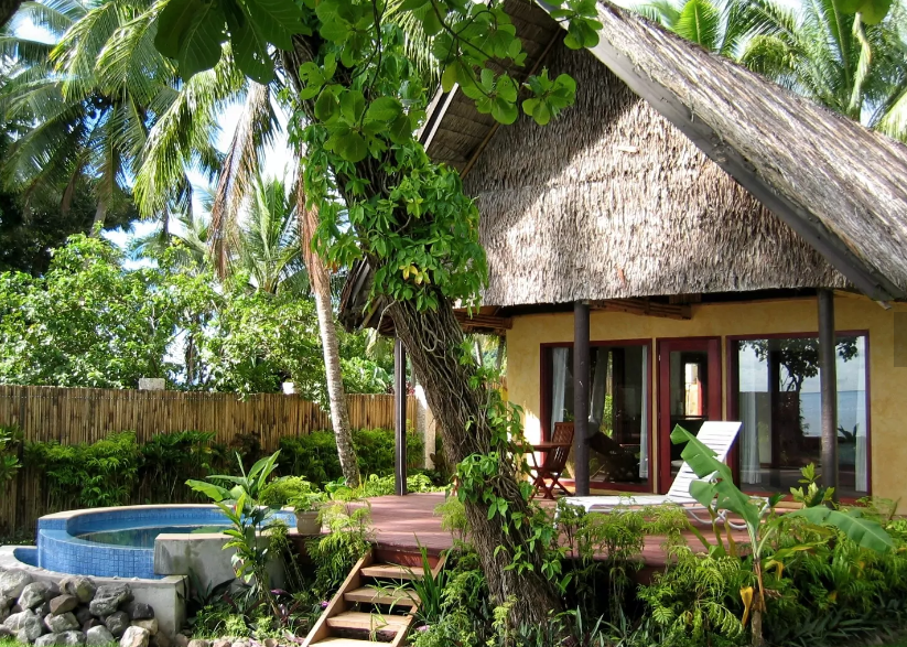 Thumbnail: a thatched cottage with steps amid the rainforest