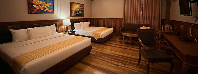 a hotel room with a bed and desk_edited.