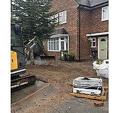 Day one: the front garden dug out by machine before the base goes in.