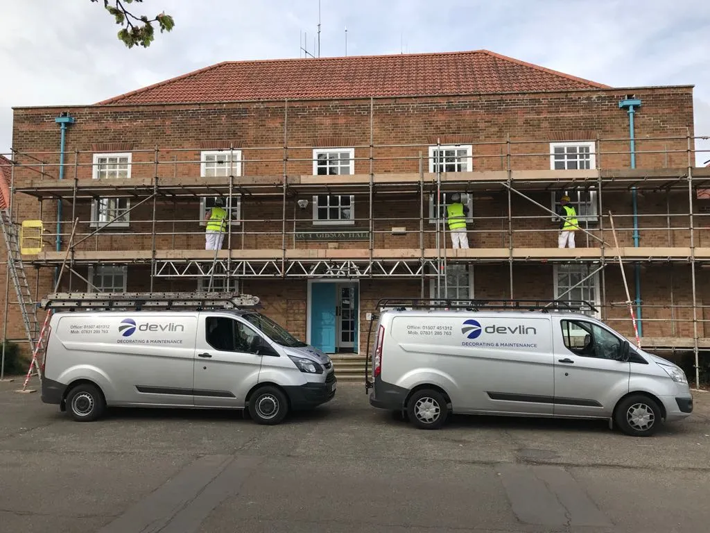 Devlin vans parked outside exterior building job with scaffolding